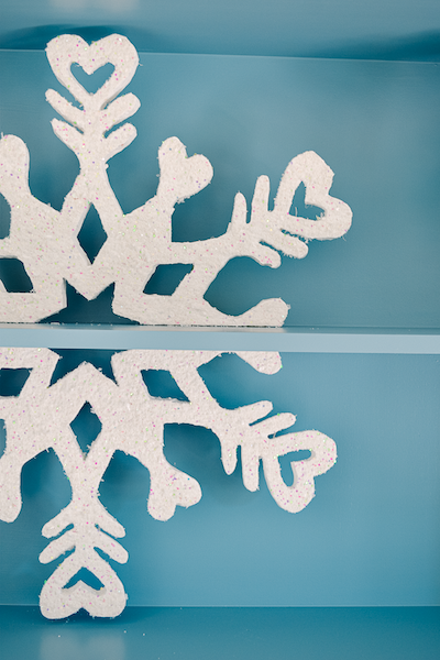 Giant snowflake design on a blue shelf.